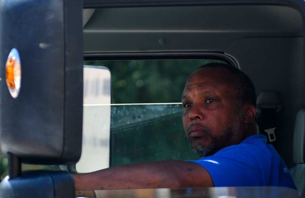 Jesse Randleman reverses a moving truck into place to unload boxes